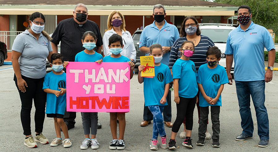 Children hold a sign that says Thank You Hotwire.